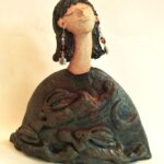 ceramic figure with hare design on torso.