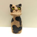 ceramic cat with pasty in mouth