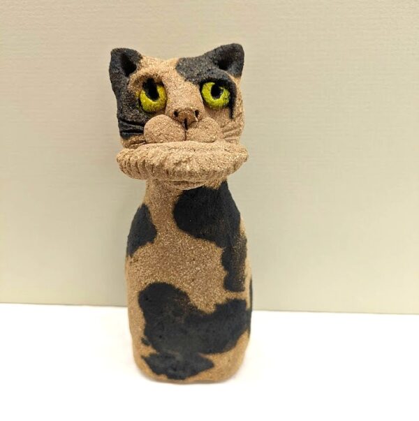 ceramic cat with pasty in mouth