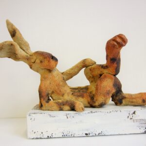 Relaxed Hare on a wooden block.