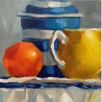 Jug and orange on a table